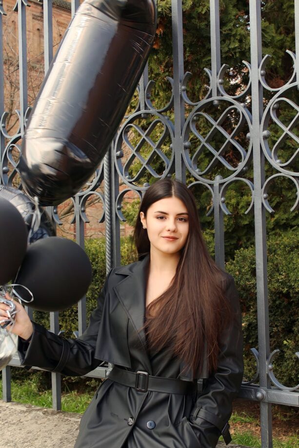 young woman with black balloons