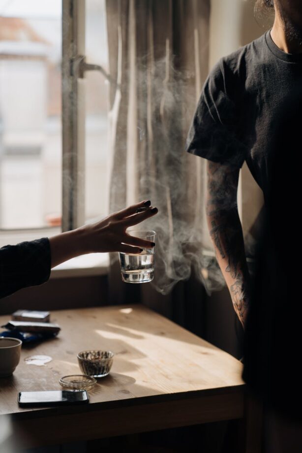 Close-up of a person holding a cigarette, reflecting on quitting addiction naturally.