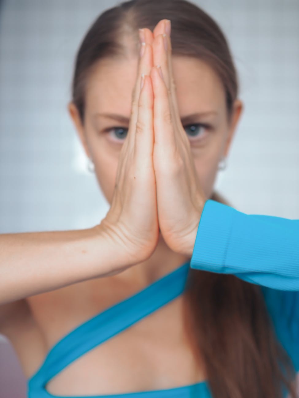 woman in blue attire doing yoga gesture
