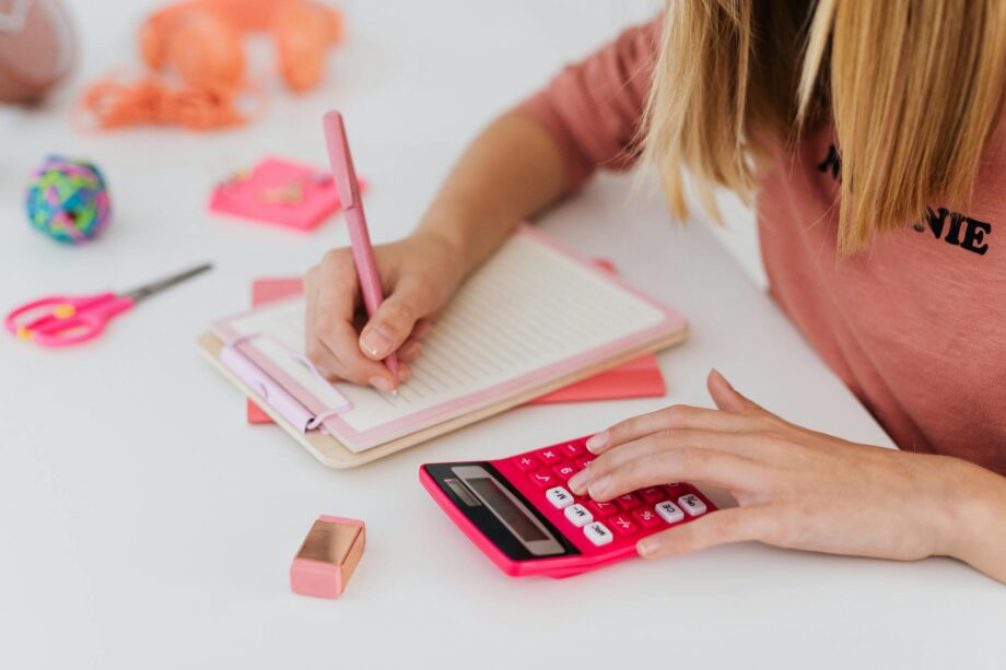girl solving an equation and using a calculator