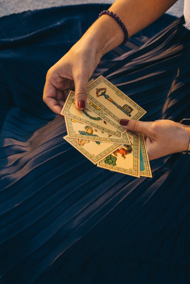 person holding tarot cards